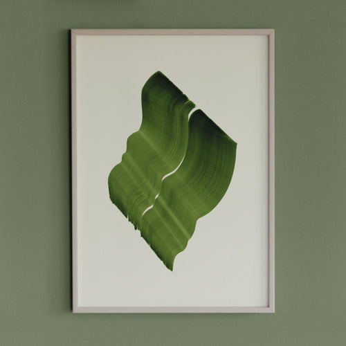 Leafy, grass green abstract artwork in a thin white oak wooden frame on a sage green wall