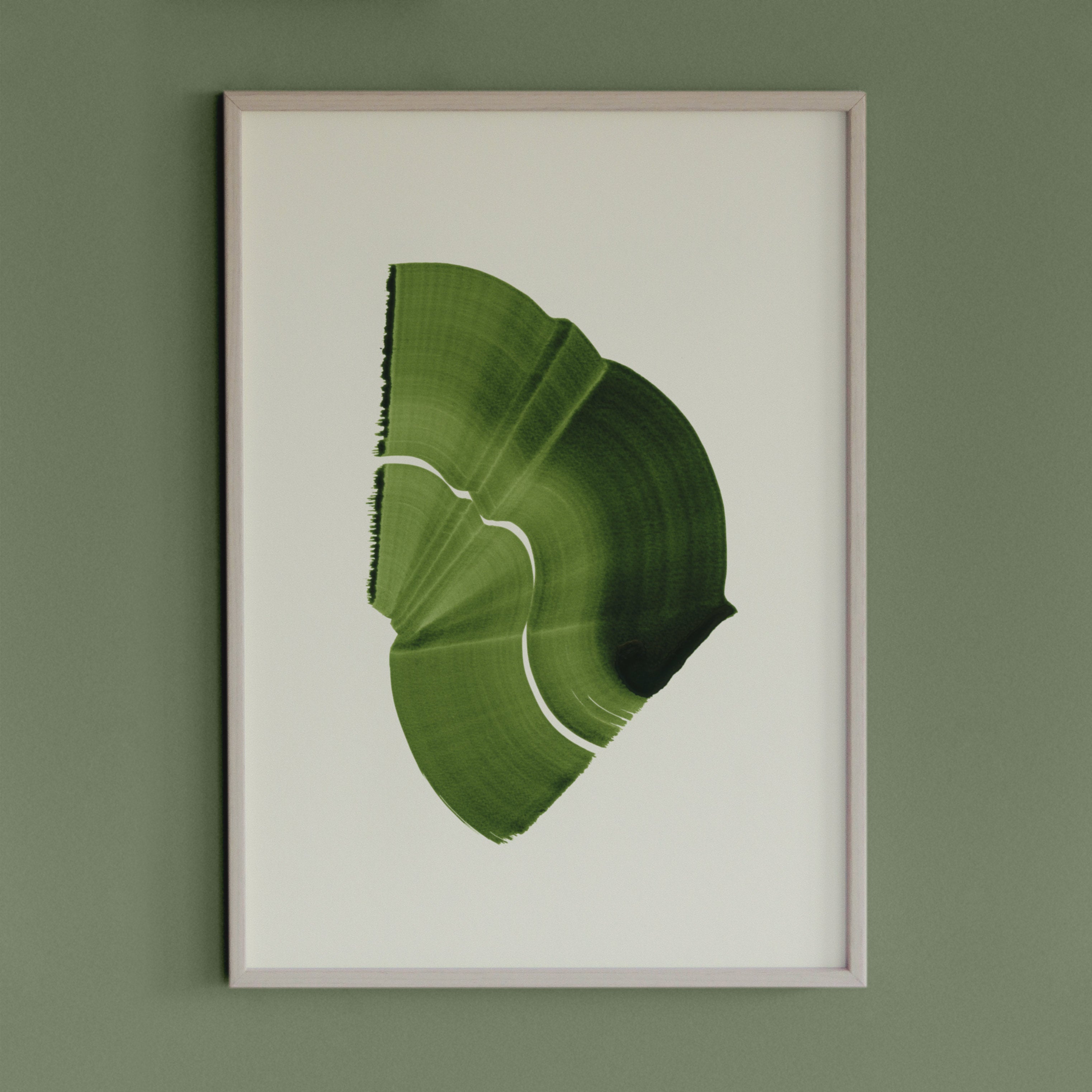 Leafy spring green abstract artwork in a thin white oak wooden frame on a sage green wall