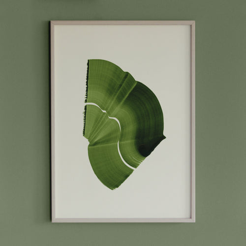 Leafy spring green abstract artwork in a thin white oak wooden frame on a sage green wall