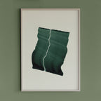 Deep green wavy abstract artwork in a thin white oak wooden frame on a sage green wall