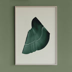 Deep forest green abstract artwork in a thin white oak wooden frame on a sage green wall