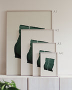 Set of framed green art prints with abstract leaf designs on a neutral background, showing in sizes A4, A3, A2 and A1