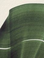 Green abstract painting, fine art print. Close-up detail shot of the high quality print, the textured bamboo paper, the curved shape and pattern, vibrant colours and fine detail.