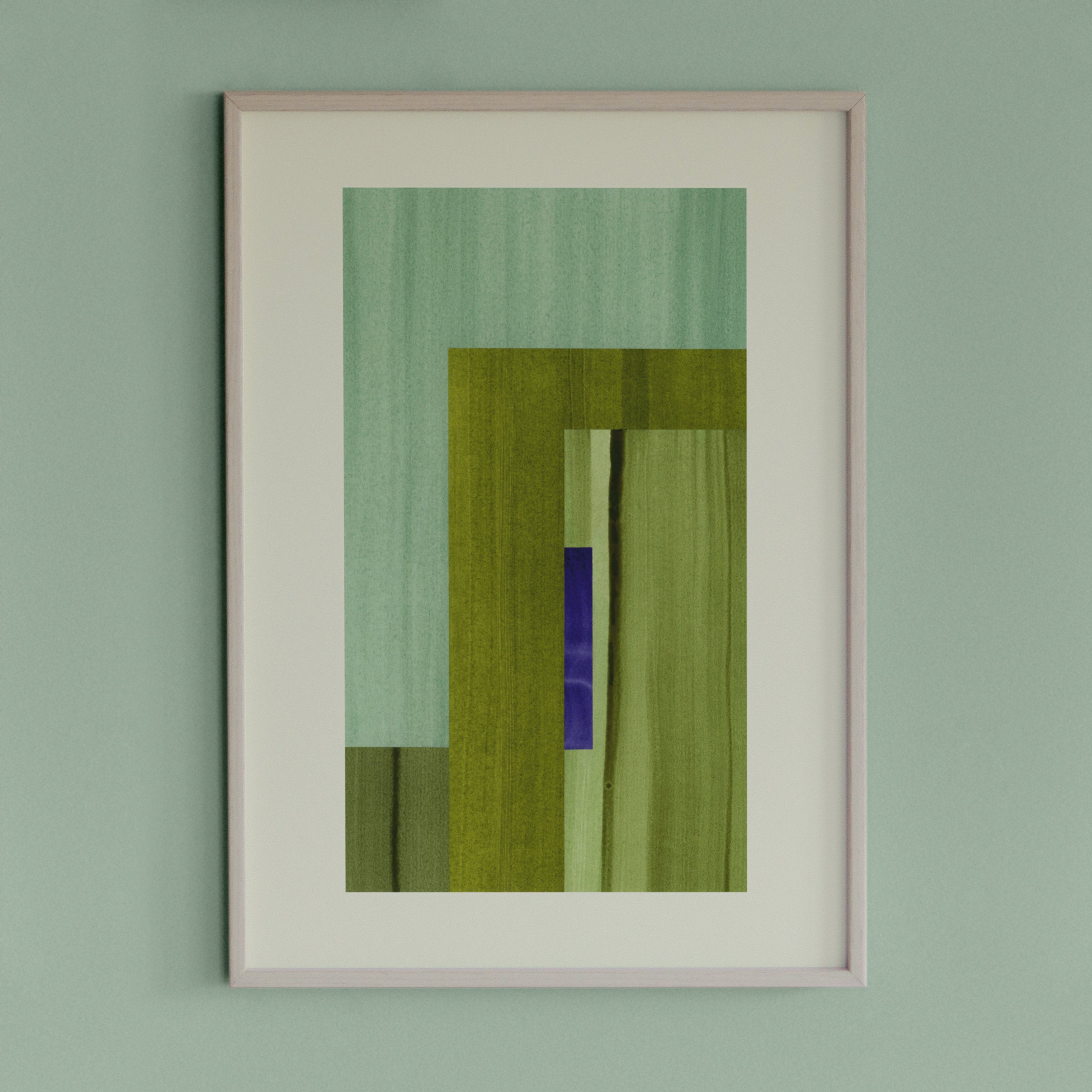 Framed geometric abstract art piece with moss green, turquoise and blue colours on a light green wall.