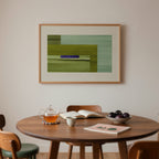 Mid century dining room with a wooden table, chairs, and a framed abstract artwork on the wall.