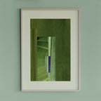 Framed geometric abstract art piece with moss green, sage green and blue colours on a light green wall.