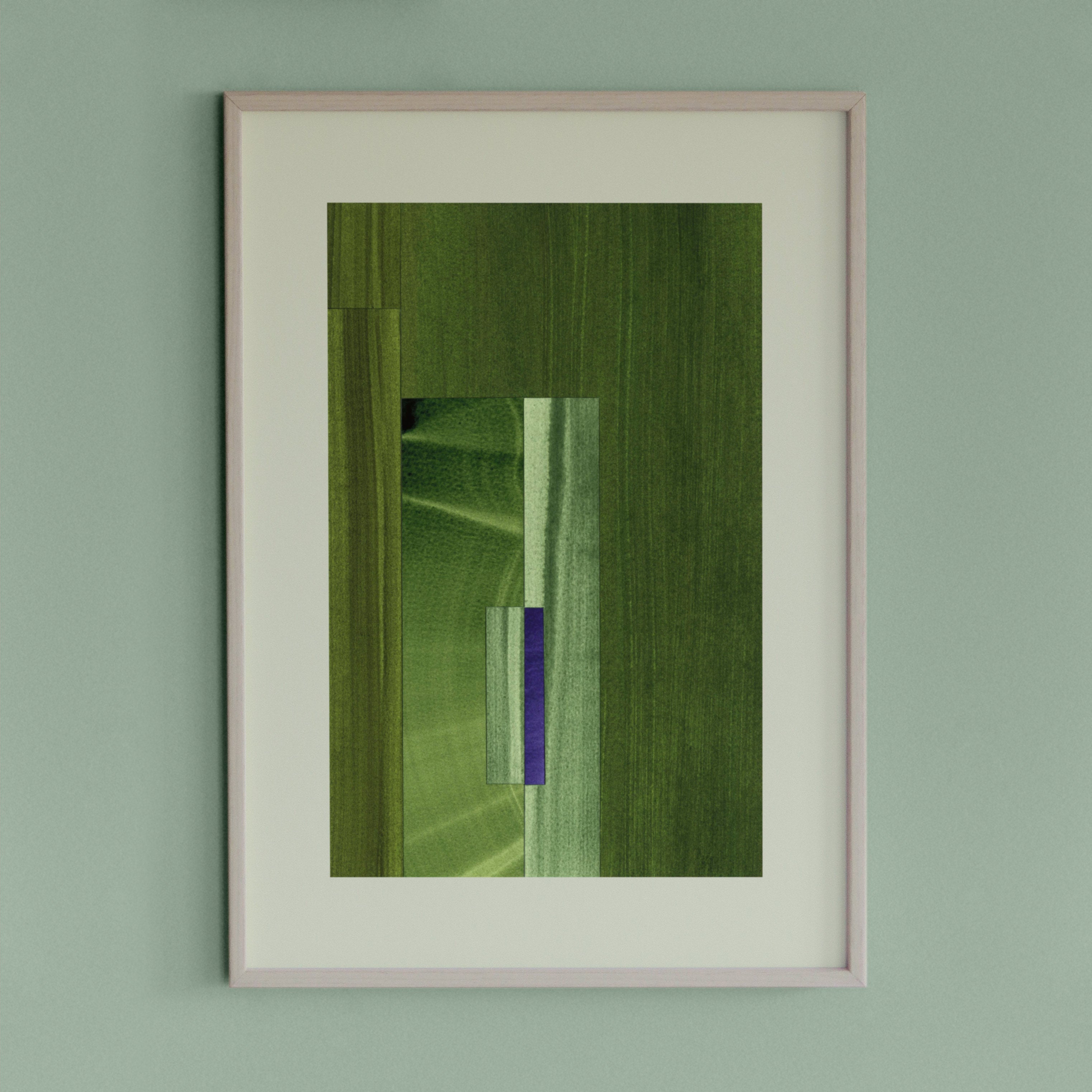 Framed geometric abstract art piece with moss green, sage green and blue colours on a light green wall.