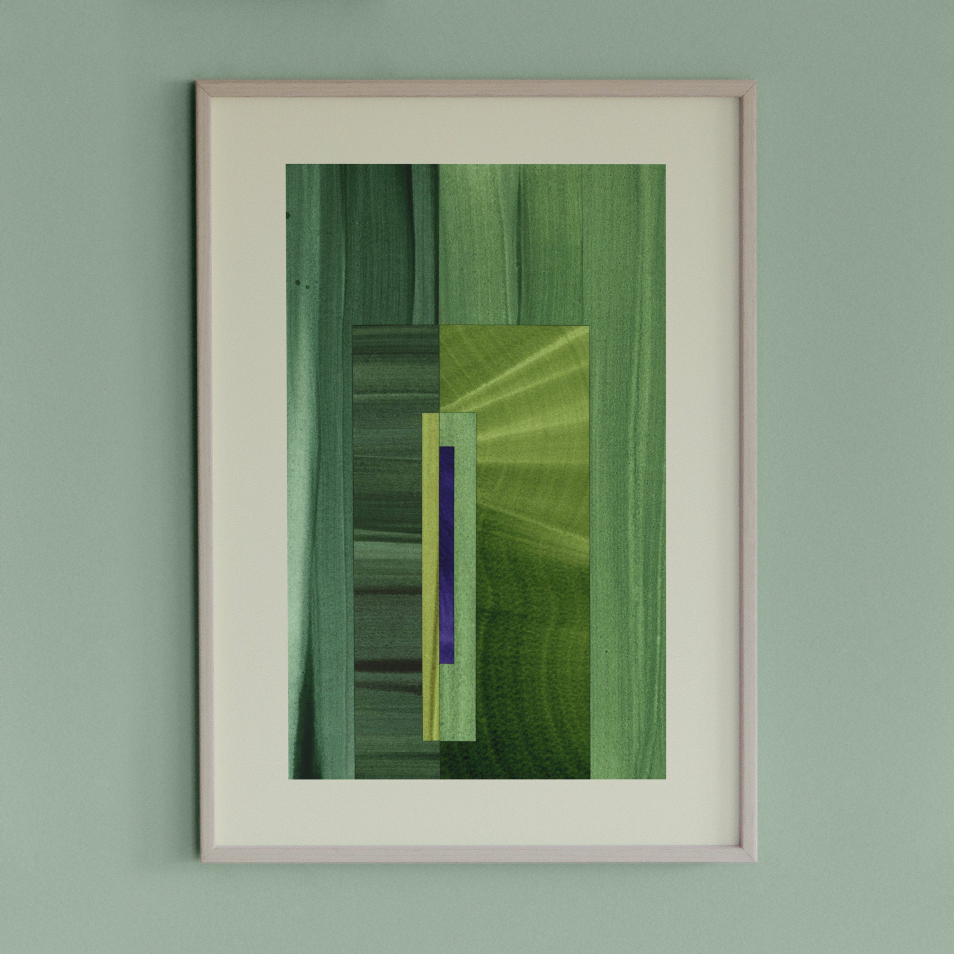 Framed geometric abstract art piece with grass green and blue colours on a light green wall.