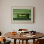 Mid century dining room with a wooden table, chairs, and a framed green abstract artwork on the wall.