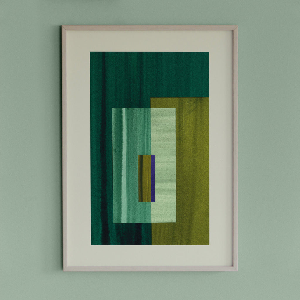 Framed green abstract art piece with green and blue colours on a light green wall.