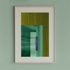 Framed green geometric abstract art piece with green and blue colours on a light green wall.