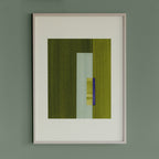Geometric abstract artwork with green and blue/purple colours, in a thin white oak wooden frame on a teal/aquamarine grey wall