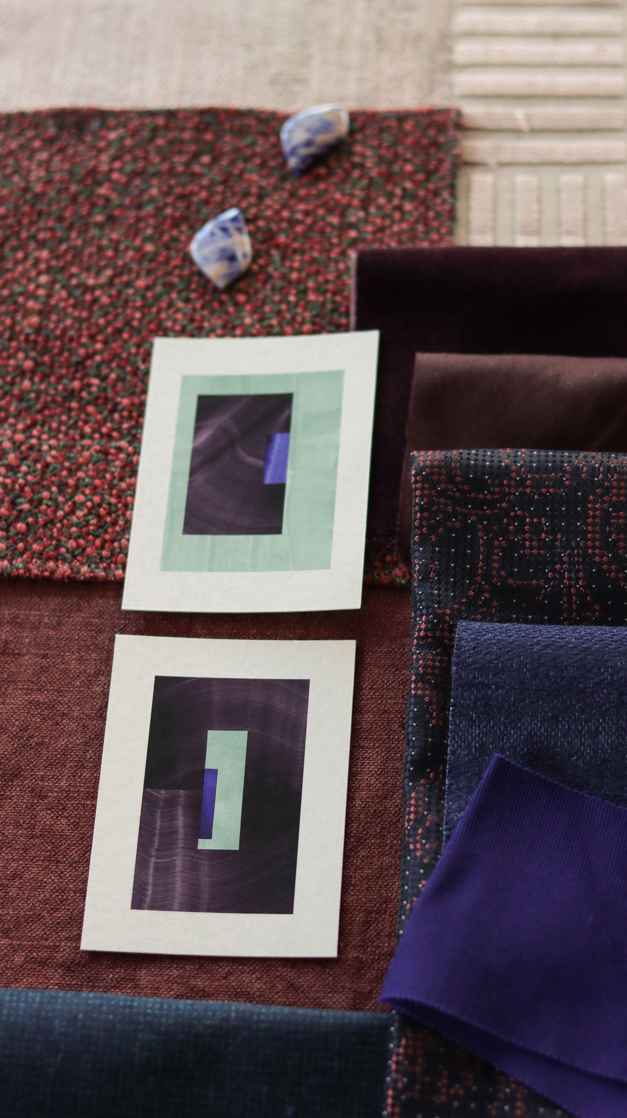Turquoise and eggplant purple geometric abstract art print samples with fabric swatches in rust orange and dark blue. Inspiration for rust orange and dark blue themed interior design.