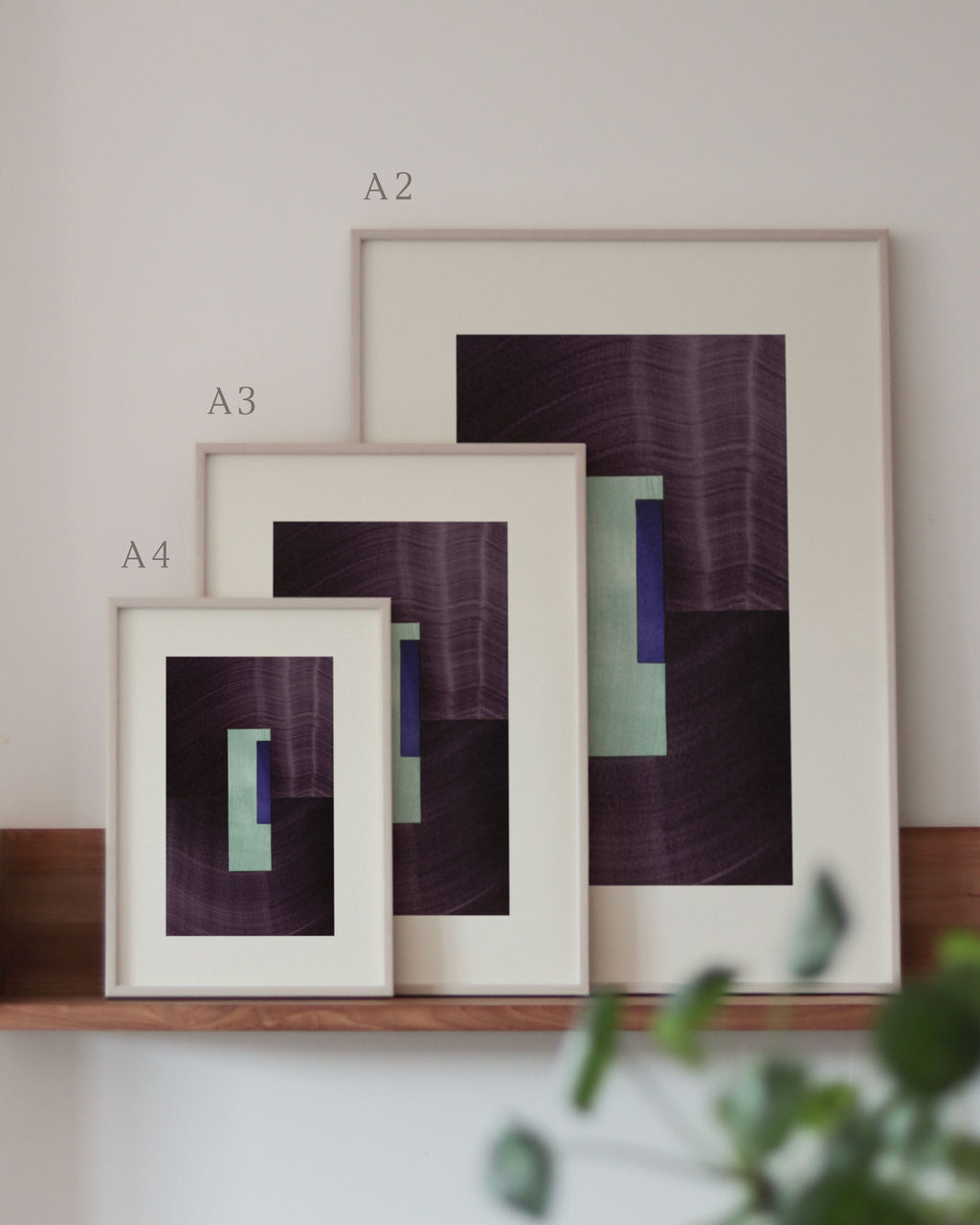 Set of eggplant purple and turquoise framed geometric abstract art prints on a neutral background, showing in sizes A4, A3, and A2