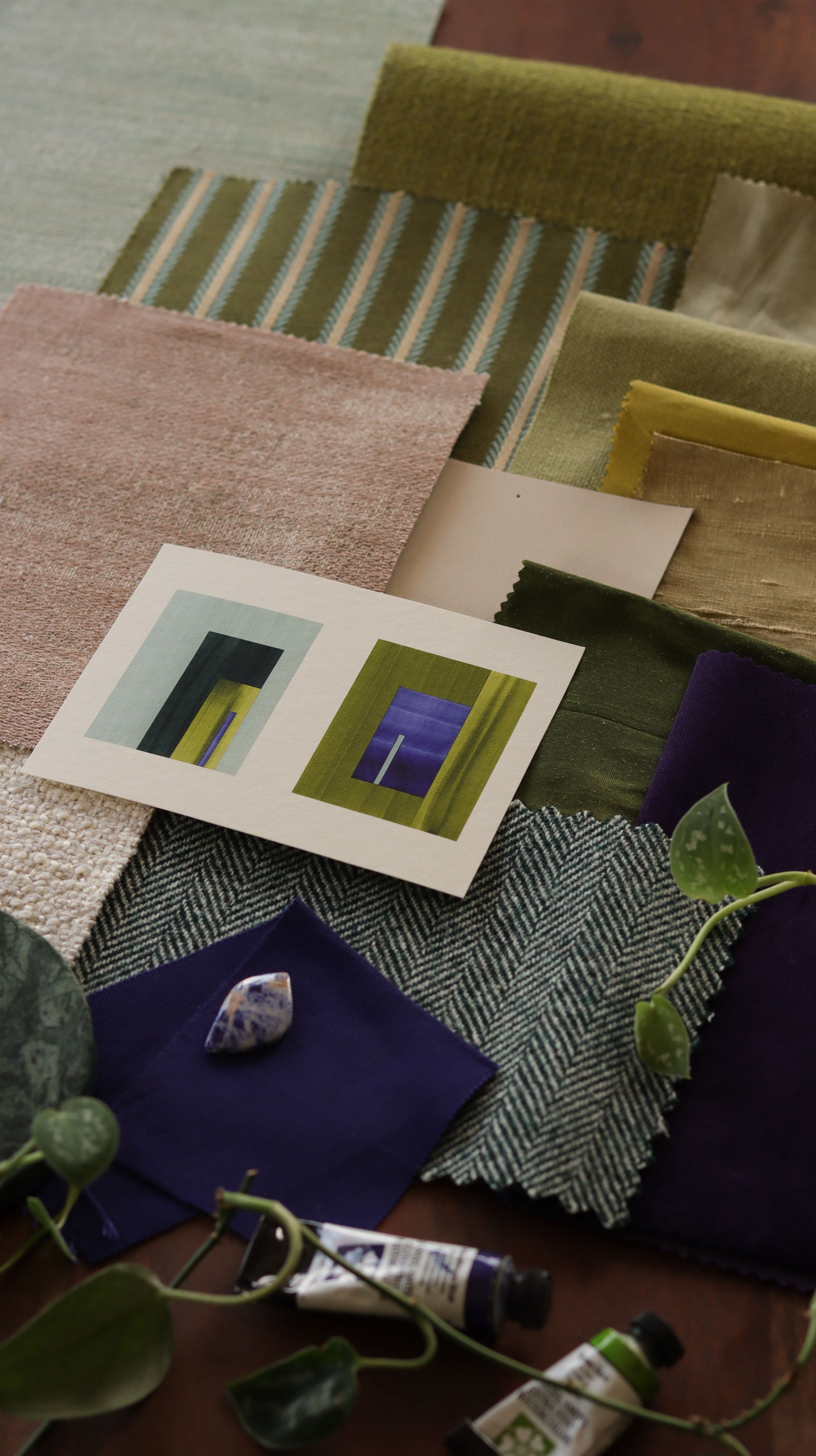 Blue, moss green and turquoise geometric abstract art print samples with fabric swatches. Inspiration for green and blush pink themed interior design.