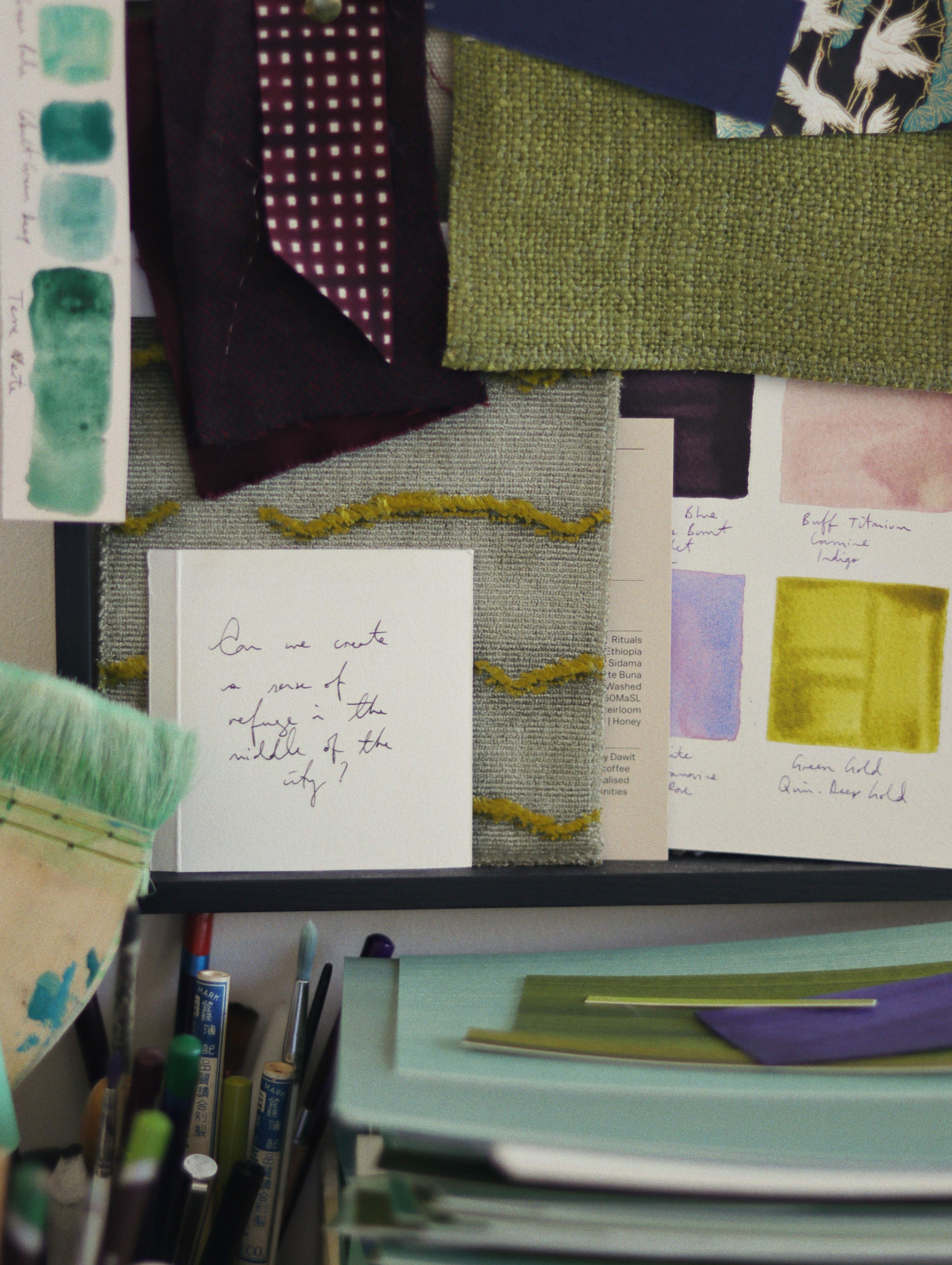 Pinboard with abric and paint swatches in abstract artist Aimee Johanan's art studio