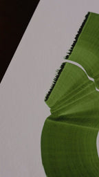 Slow close-up detail footage of a green abstract art print on fine art paper